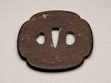 a small iron tsuba with two holes in the middle