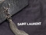 a black bag with a silver chain tassel on it