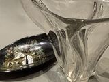 un saladier en verre et une cuillère posés sur une table