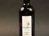 the bottle of red wine is sitting on the table