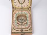 a small wooden box with a compass inside of it