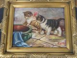 a painting of a cat and a dog in a gold frame
