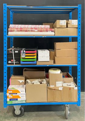 a blue shelf with many boxes and boxes on it