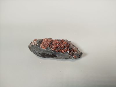 a small rock that is sitting on a white surface