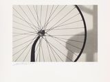 a black and white photo of a bicycle wheel