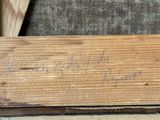 a piece of wood that has writing on it