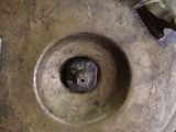 a close up of a metal object on a black background