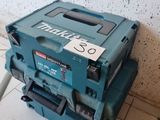 a blue tool box sitting on the floor next to a wall
