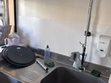 a kitchen with a sink and a window in it