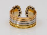 an image of a gold and silver ring sitting on top of a white surface