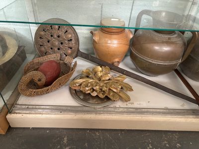 a glass display case with a variety of items on it