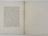 an open book with a page in it on a table