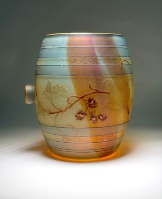 a glass cup with a dragon on it on a table
