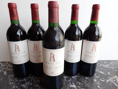 four bottles of wine are lined up on a table