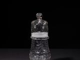 a small glass jar with a lid on a table