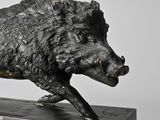 statue of a boar on a marble base on a white background