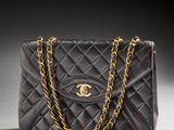 a black chanel bag with a gold chain strap