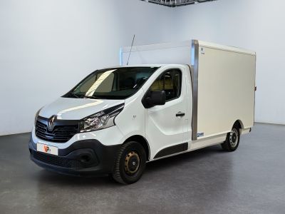 La camionnette blanche est garée dans une grande pièce équipée d'un ventilateur de plafond.