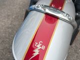 a close up of a motorcycle with a red and white stripe on it