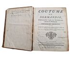 an old book opened to show the title of a novel