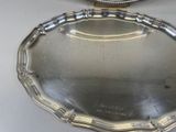 a silver tray with a clock on top of it