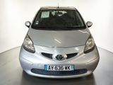 a silver toyota yaris parked in a white room