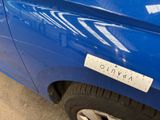 a blue car with a sticker on the side of it