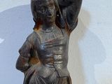a statue of a woman with a hat on her head