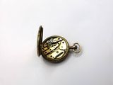a small gold pocket watch with a chain attached to it