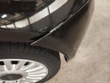 a close up of a black car with a white stripe on it