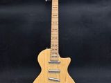 an electric guitar with a wooden body on a black background