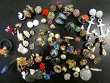 many different types of jewelry on a black table