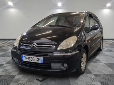 a picture of a small black car parked in a garage