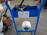 a blue cart with a roll of toilet paper and a roll of toilet paper in it
