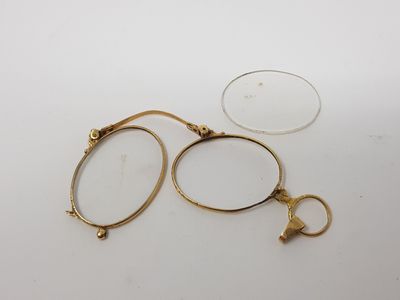 a pair of glasses sitting on top of a table next to a pair of scissors