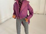 a figurine of a man wearing a purple coat and hat