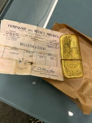 a piece of gold on a piece of paper on a table