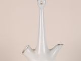 a white vase with a silver handle on a table