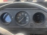 un volant et des instruments de bord dans le tableau de bord d'une vieille voiture