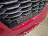 a close up of a car ' s grille with a ruler on it