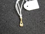 a white tag with a gold tear hanging from it