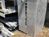 a machine that is sitting on the ground next to a pile of trash