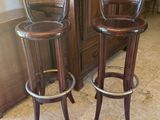 two wooden stools sitting next to each other in a room