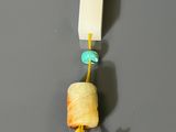 three pieces of wood that are hanging on a string
