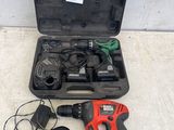 a corded drill in a case with other tools