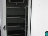 a refrigerator that is open in a small room