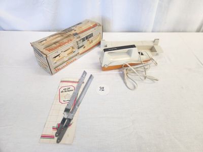 a box of scissors and a pair of scissors on a table
