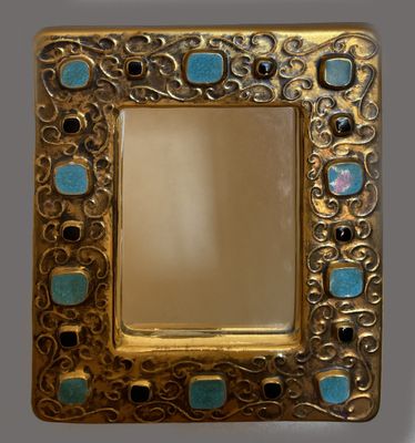 an image of a gold frame with blue stones in it