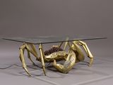 a glass table with a gold crab on it