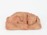 figurine of a sleeping dog on a rock